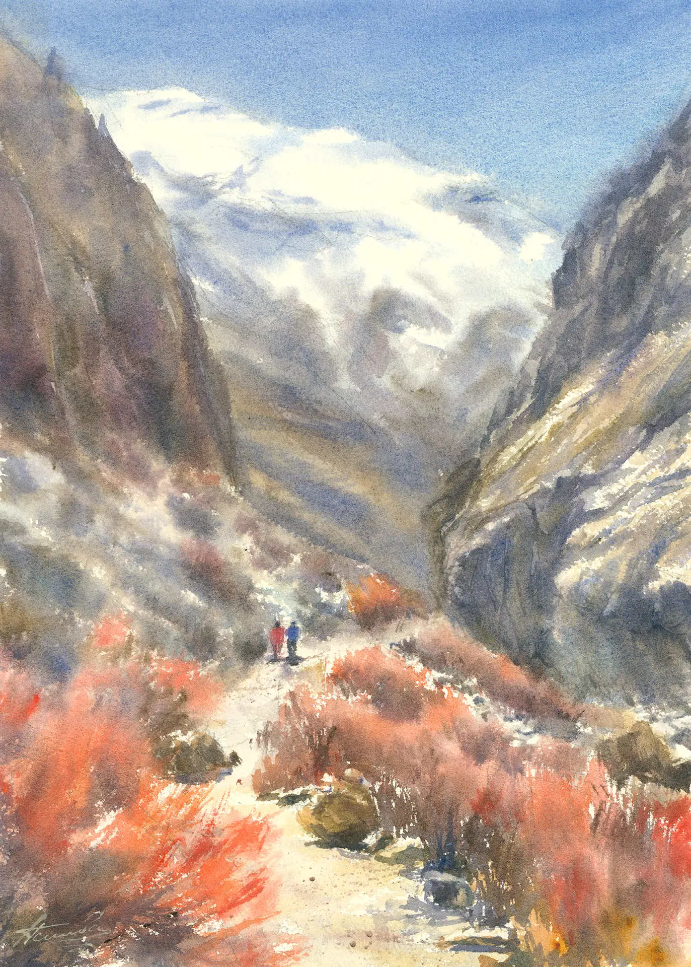 Two trekkers walk a Nepalese mountain trail between dark valley walls, autumn shrubs blazing red along the path and a snow-capped peak rising in the cloud beyond.